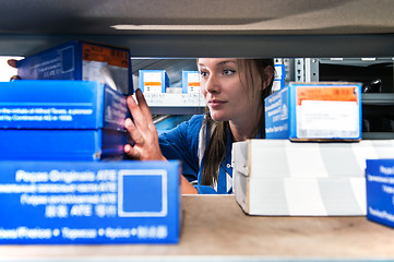 Image showing Mechanic picking up spare parts