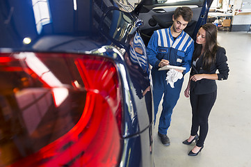 Image showing Mechanic in car garage with customer