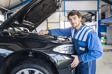 Image showing Car mechanic under the hood