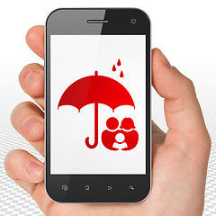 Image showing Security concept: Hand Holding Smartphone with Family And Umbrella on display