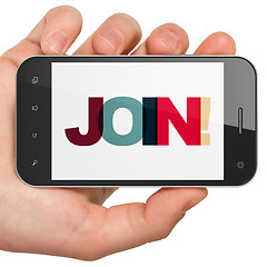 Image showing Business concept: Hand Holding Smartphone with Join! on  display