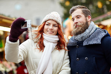 Image showing couple taking selfie with smartphone in old town