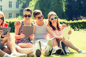 Image showing smiling friends with tablet pc computers in park