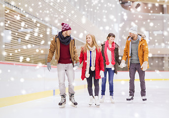 Image showing happy friends on skating rink