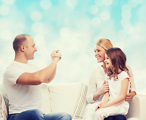 Image showing happy family with camera at home