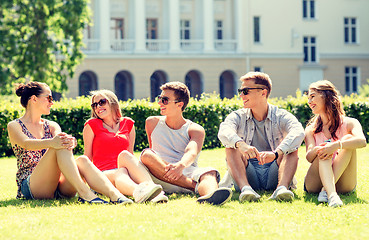 Image showing group of smiling friends outdoors sitting on grass