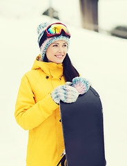 Image showing happy young woman with snowboard outdoors