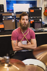 Image showing male musician with cymbals at music store