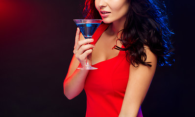Image showing close up of sexy drinking cocktail at nightclub