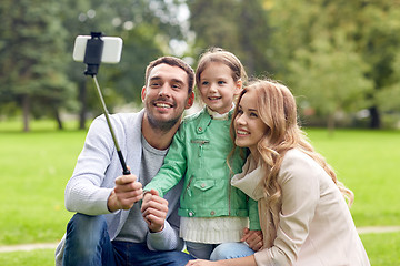 Image showing happy family taking selfie by smartphone outdoors