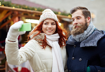 Image showing couple taking selfie with smartphone in old town