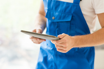 Image showing close up of builder or workman with tablet pc