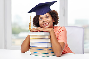 Image showing happy african bachelor girl with books at home