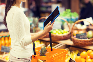 Image showing woman with basket and tablet pc in market