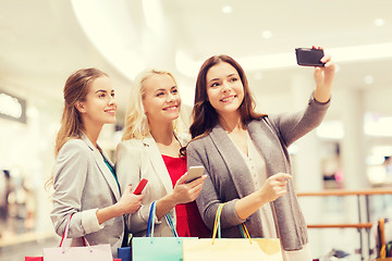 Image showing women with smartphones shopping and taking selfie