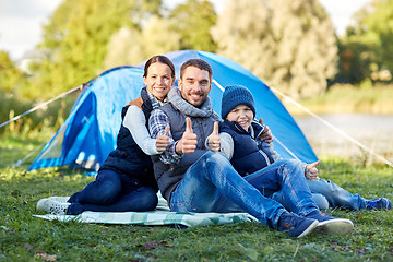 Image showing happy family with tent at camp site