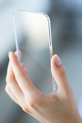 Image showing close up of woman with transparent smartphone