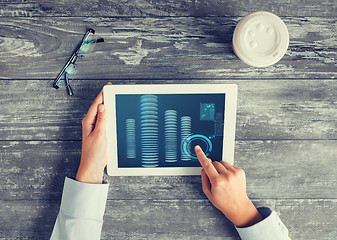 Image showing close up of hands with tablet pc and bitcoin