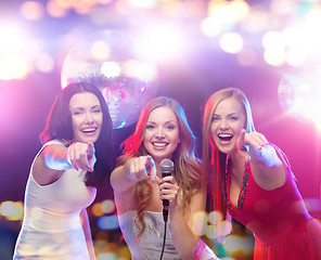 Image showing happy women singing karaoke and dancing