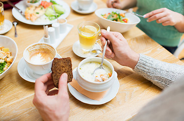 Image showing close up man eating soup for dinner at restaurant