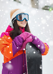 Image showing happy young woman with snowboard outdoors