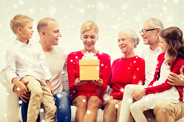 Image showing smiling family with gifts at home