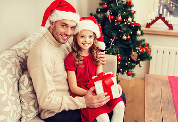 Image showing smiling father and daughter holding gift box