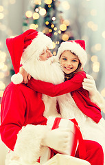 Image showing smiling little girl with santa claus