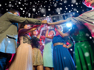 Image showing smiling friends with glasses of champagne in club