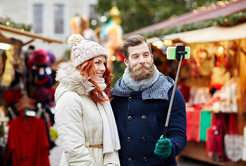 Image showing couple taking selfie with smartphone in old town