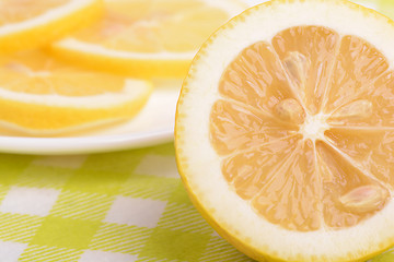 Image showing Background of yellow ripe lemons. A slice of lemon.