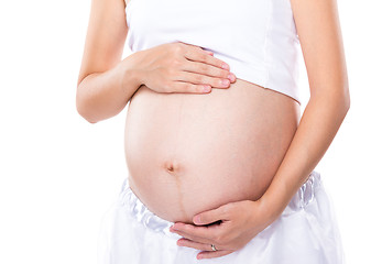 Image showing Pregnant woman touching her belly with hand