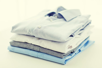 Image showing close up of ironed and folded shirts on table