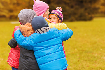 Image showing group of happy children hugging in autumn park