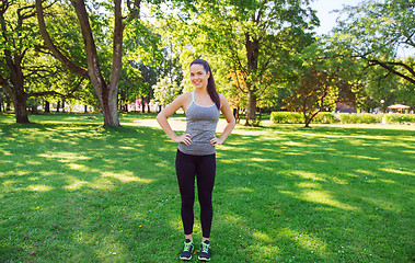 Image showing happy young woman exercising outdoors