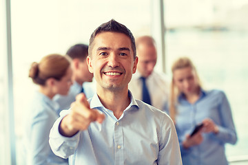 Image showing group of smiling businesspeople meeting in office