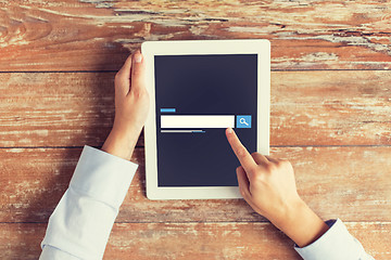 Image showing close up of male hands using browser on tablet pc