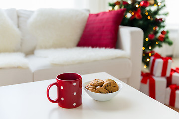 Image showing close up of christmas cookies and red cup on table