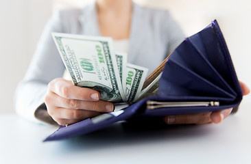 Image showing close up of woman hands with wallet and money