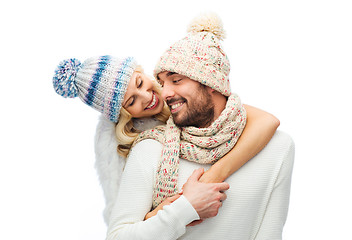 Image showing smiling couple in winter clothes hugging