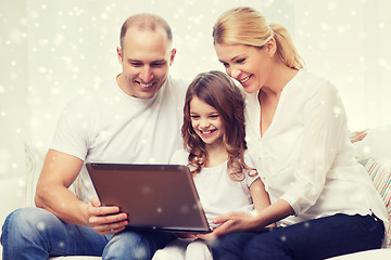 Image showing smiling family with laptop at home