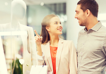 Image showing happy young couple with shopping bags in mall