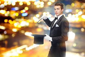 Image showing magician in top hat with magic wand showing trick