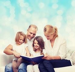 Image showing happy family with book at home