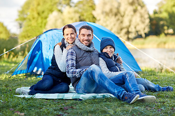 Image showing happy family with tent at camp site