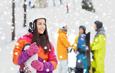 Image showing happy friends in helmets with snowboards