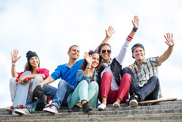 Image showing group of teenagers waving hands