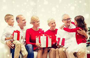 Image showing smiling family with gifts at home