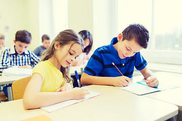 Image showing group of school kids writing test in classroom