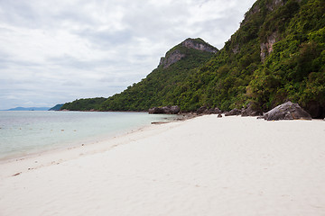 Image showing Beach on tropical island. Clear blue water, sand, clouds. 